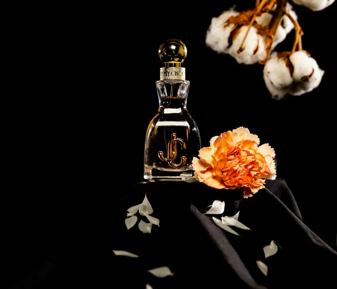 Ornate amber and gold perfume bottles with oud wood