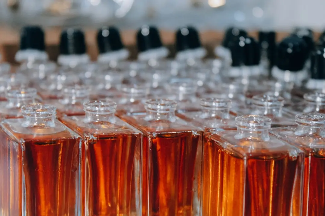 Rows of fragrance bottles arranged on a retail display shelf